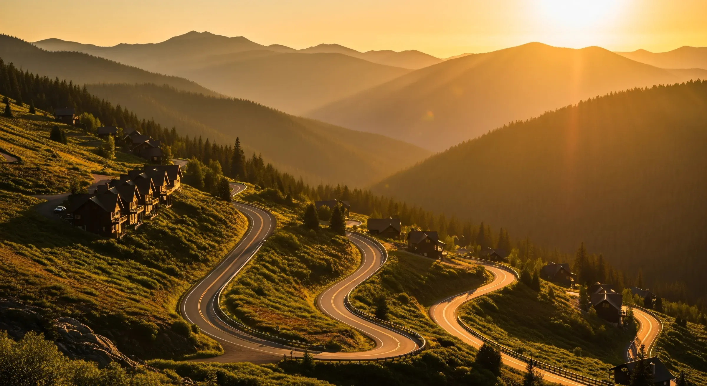A mountain road at dusk leading toward a portfolio of vacation rental cabins — the operating context behind the Three Models framework, where full-service property management is one of three legitimate answers and only the right answer for a specific operator profile